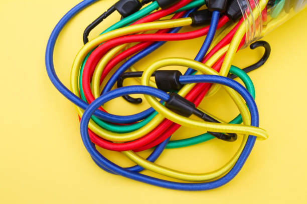 istock Group of multicolored bungee cords on a yellow colored background 904657908