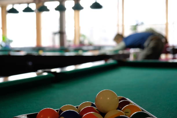 istock Teen playing in american pool billiard. 904657956