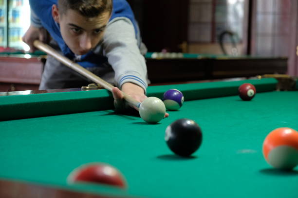 istock Teen playing in american pool billiard. 904657992