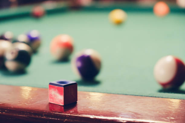 Ball and chalk on the billiard table.