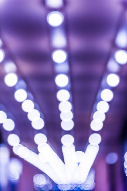 istock Abstract bokeh background of blue lights in alley passage leading to exit 904658526