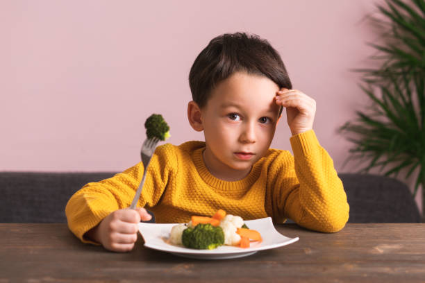 istock Child is very unhappy with having to eat vegetables. 904658922