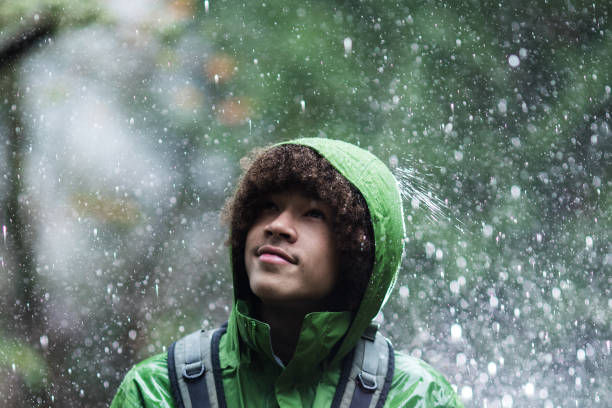 istock Young Man Hiking in Rain with Waterproof Jacket 904658982