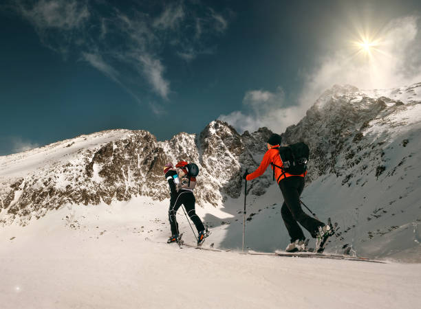 istock Two women ski walkers go up on the mountain top 904659066
