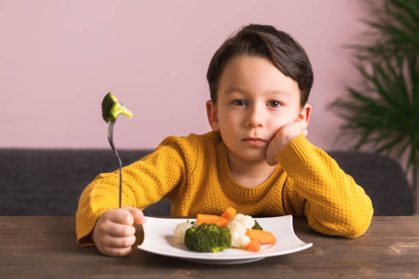 istock Child is very unhappy with having to eat vegetables. 904661406