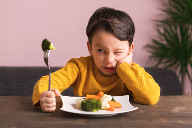 istock Child is very unhappy with having to eat vegetables. 904661468