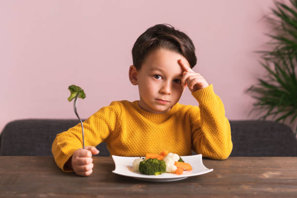 istock Child is very unhappy with having to eat vegetables. 904661496