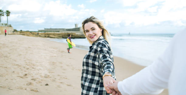 istock Romantic couple Holding hands on the beach 904665576