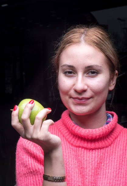 istock Woman with green apple 904666796