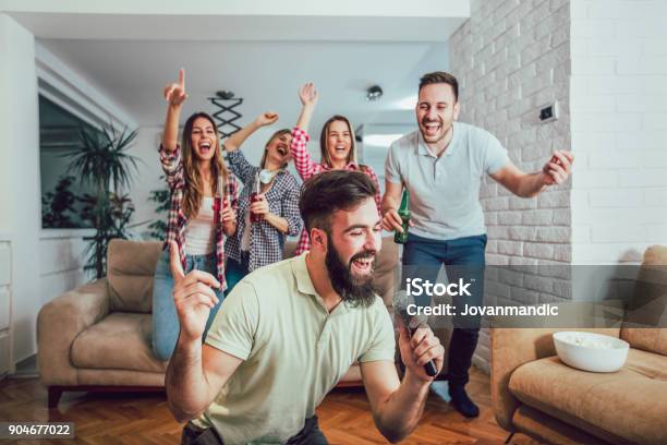 Group Of Friends Playing Karaoke At Home Stock Photo - Download Image Now - Friendship, Karaoke, Party - Social Event