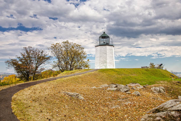 istock Stony Point Lighthouse with Trees in Autumn Colors (Foliage), Rocks, Hudson River and Cloudy Sky, Stony Point Battlefield State Historic Site, Hudson Valley, New York. 904679538