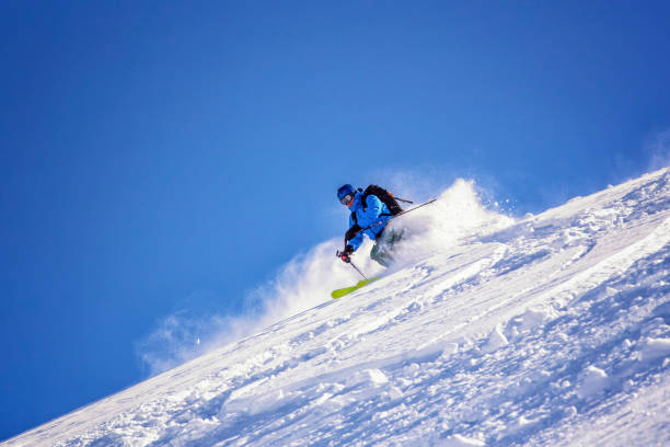 istock Freeride skier charging through powder snow 904680386