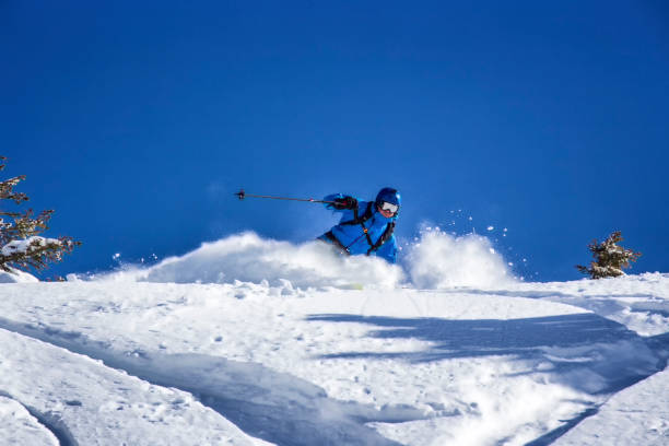 istock Freeride skier charging through powder snow 904680522