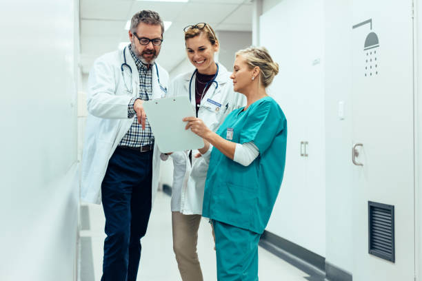 istock Team of doctors working on patients file at hospital 904683524