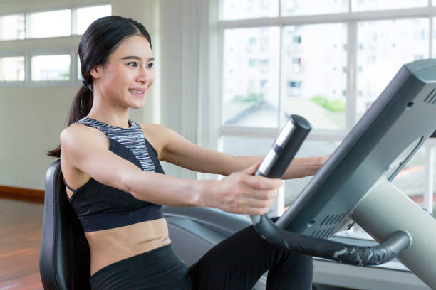istock Woman happiness when she exercise by exercise bike. 904694592