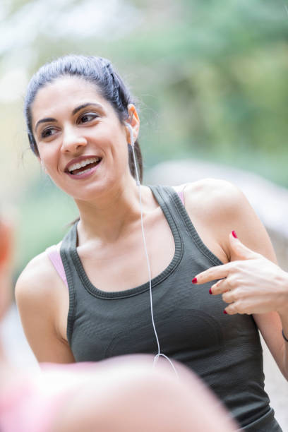 istock Woman talks with friend while exercising 904694670