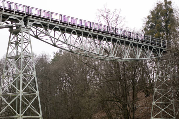 istock A bridge over a river built from a truss. Bridge, truss joined by rivets in old technology on the river. Winter campery. 904697146