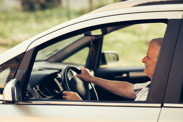 istock Senior man driving car 904697892