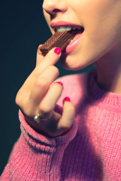 istock Woman eating chocolate cookie 904698548
