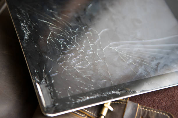 istock Tablet computer with broken glass screen on the wood background 904698930