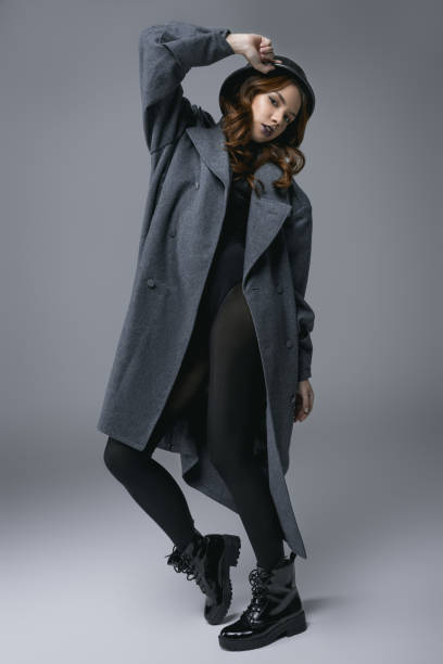 istock beautiful model posing in autumn coat and military helmet 904709702