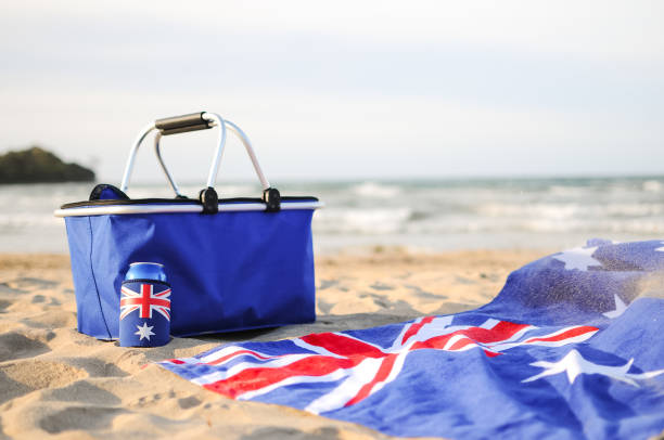 Cooler, drink and beach towel on the sand of a northern Tasmanian Beach in Australia.