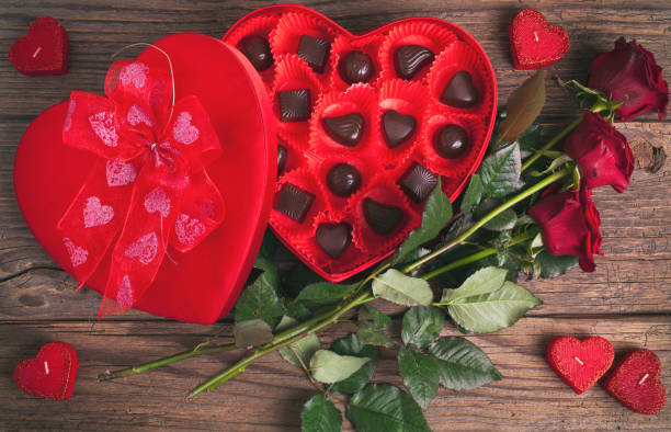 istock Heart chocolate box and red roses on wooden rustic background 904720950