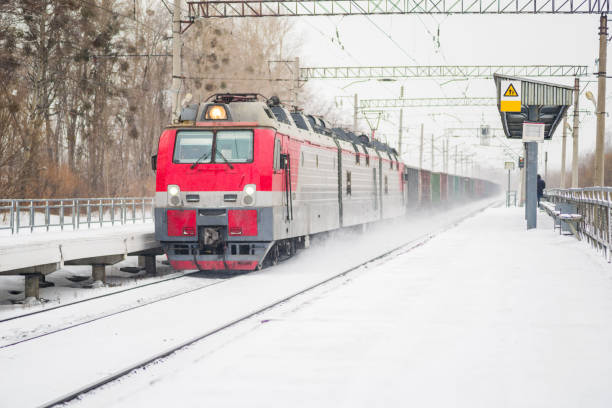 istock transportation. train arriving at the railway station in winter 904732352