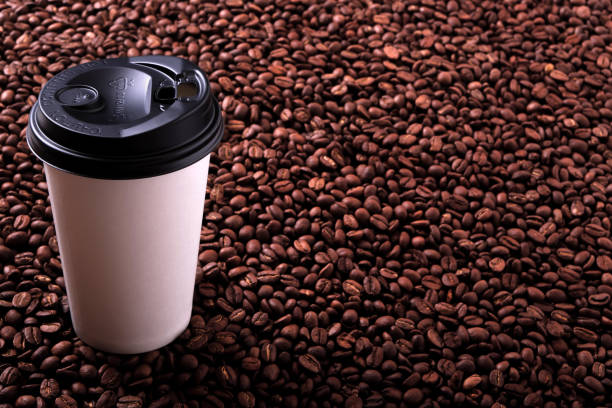 istock Takeaway coffee cup with roasted beans background 904737380