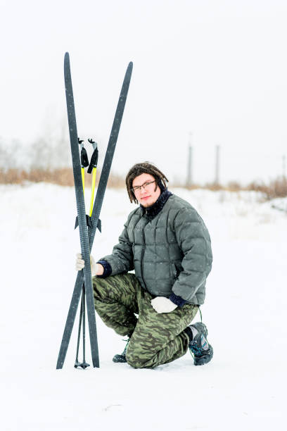 istock young man with dreadlocks sitting on the snow with ski equipment 904740470