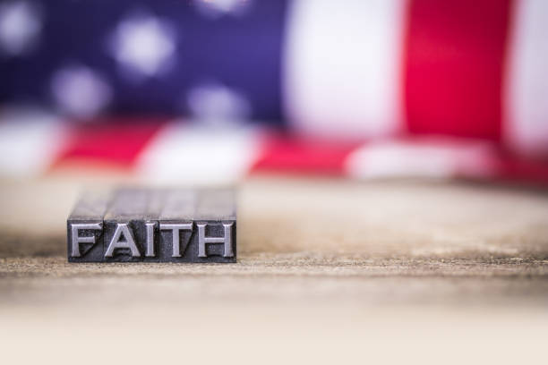 istock Faith Concept Letterpress Word with American Flag 904742440