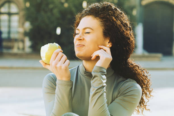 istock Beautiful woman eating an apple 904766082
