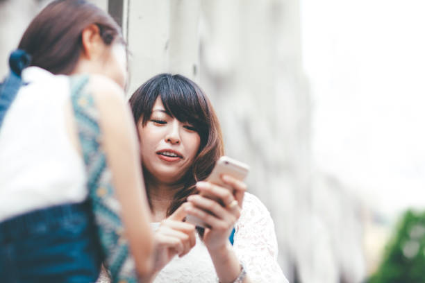 istock Female Friends Looking At Smart Phone 904767046