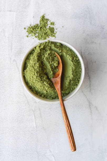 istock Green matcha tea powder. Top view. Vertical photo. 904776910