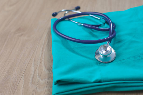 istock Stethoscope on a table with medical uniform 904780212