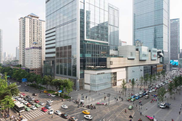 Crossroads in Chengdu with IFS buildings in the background Chengdu, China - April 26, 2016 : Car traffic in downtown crossroads with IFS buildings in the background what-if-concept stock pictures, royalty-free photos & images