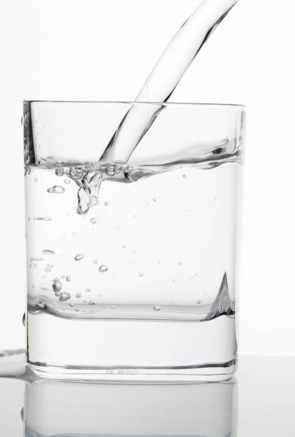 istock Water being poured into a glass on table 904781012