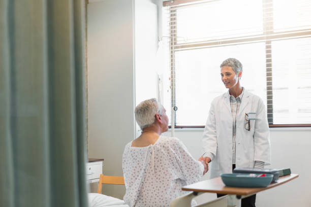 istock Female doctor shaking hands with senior patient 904793830