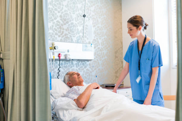 istock Doctor looking at senior patient lying on bed 904794114