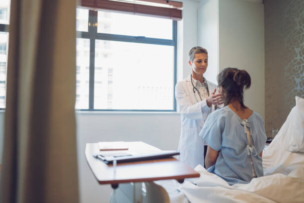 istock Smiling doctor with clipboard looking at patient 904801746