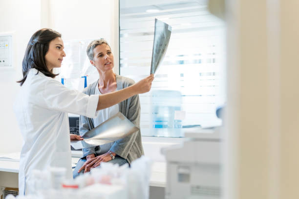 Female doctor explaining x-rays to mature patient