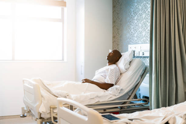 istock Male patient lying on bed in hospital 904802884