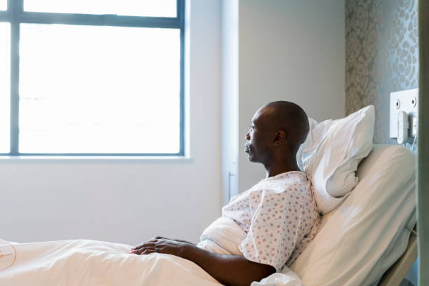 istock Male patient looking through window in hospital 904802900