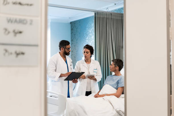 istock Doctors discussing over reports by female patient 904803032