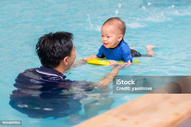 Asian Father Take Cute Little Asian 18 Months 1 Year Old Toddler Baby Boy Child To Swimming Class Stock Photo - Download Image Now