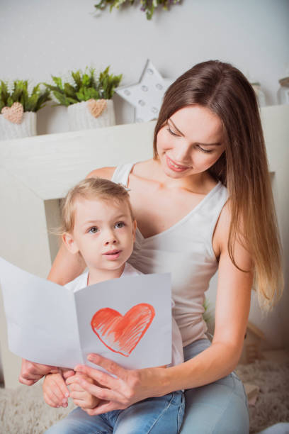 istock mother and daughter with a card in hand 904813734