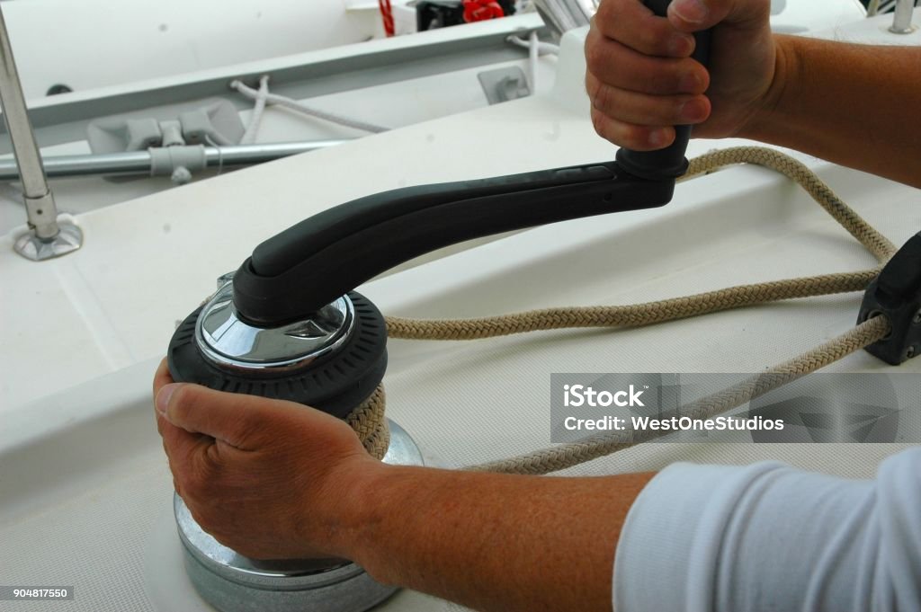 Loaded Winch Showing how to correctly load and hold a winch and handle Catamaran Stock Photo