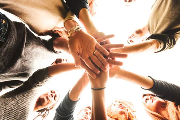 Photo of stack of hands for the teamwork of friends