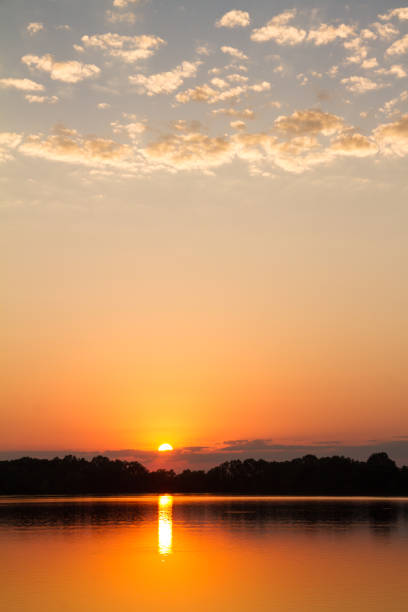 Sunset at the Schell Osage Conservation area located in the Ozarks area in Missouri.  The Lake has a reflection of the glowing sunset.