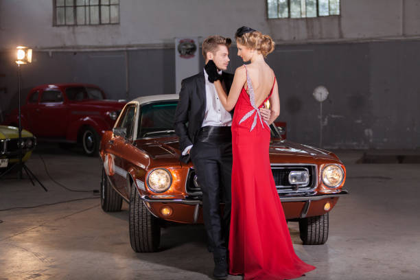 young elegance couple at the garage with her retro car - haute couture beautiful smoking beauty imagens e fotografias de stock